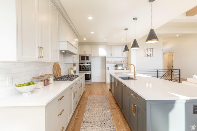 7277 W Hall Crossing Dr S, Herriman, UT 84096 - kitchen with light wood-type flooring, white cabinetry, a sink, stainless steel appliances, and decorative backsplash