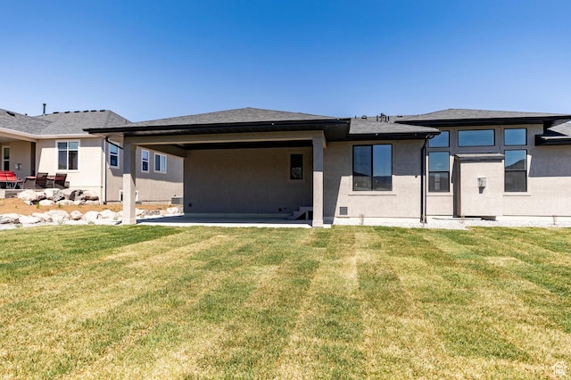 7277 W Hall Crossing Dr S, Herriman, UT 84096 - back of house with a patio area, a lawn, and stucco siding