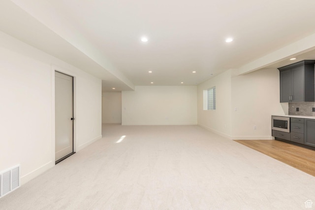 7277 W Hall Crossing Dr S, Herriman, UT 84096 - unfurnished living room with visible vents, baseboards, recessed lighting, and light colored carpet