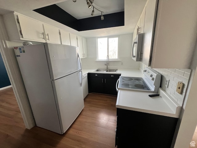 989 E Creekhill Ln S Unit 31, Midvale, UT 84047 - kitchen with white appliances, tasteful backsplash, white cabinets, and sink