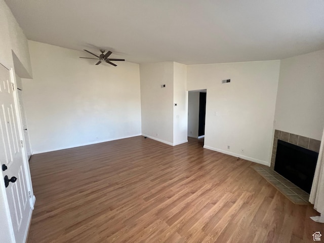 989 E Creekhill Ln S Unit 31, Midvale, UT 84047 - unfurnished living room featuring a tile fireplace, ceiling fan, and wood-type flooring