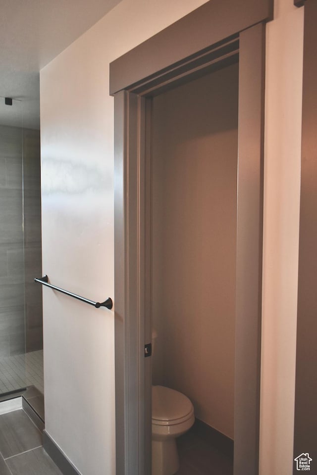 bathroom with tile patterned floors and toilet