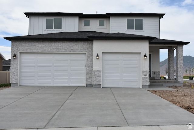 view of front of property featuring a garage and a mountain view
