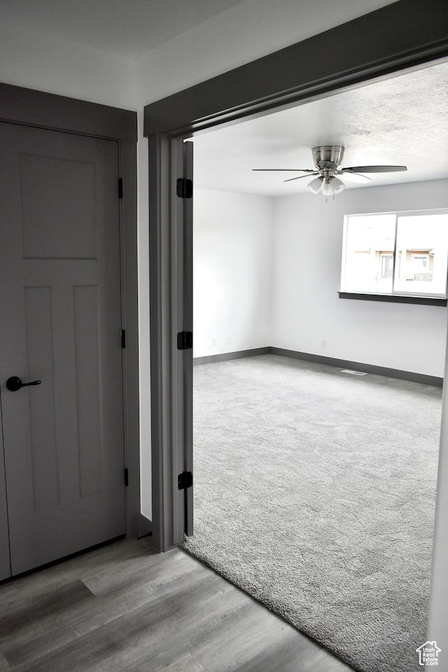 empty room featuring hardwood / wood-style floors and ceiling fan
