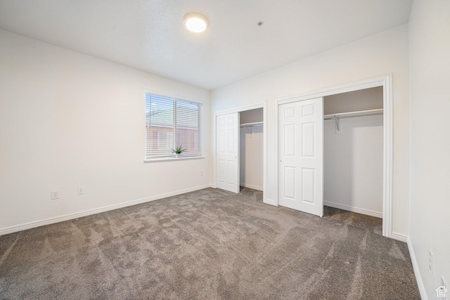 502 S 1040 E Unit 243, American Fork, UT 84003 - unfurnished bedroom featuring multiple closets and dark carpet