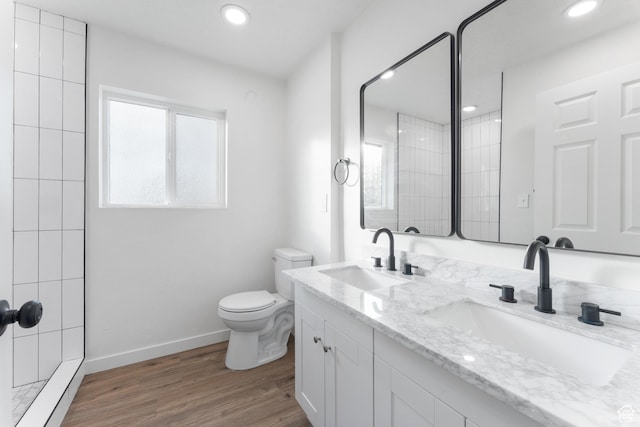 225 8th St, Ogden, UT 84404 - bathroom featuring toilet, a tile shower, wood-type flooring, and vanity