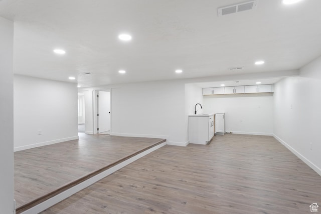 225 8th St, Ogden, UT 84404 - basement featuring sink and light wood-type flooring