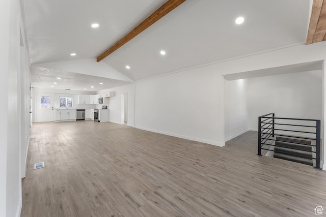 225 8th St, Ogden, UT 84404 - living room featuring lofted ceiling with beams and light hardwood / wood-style flooring