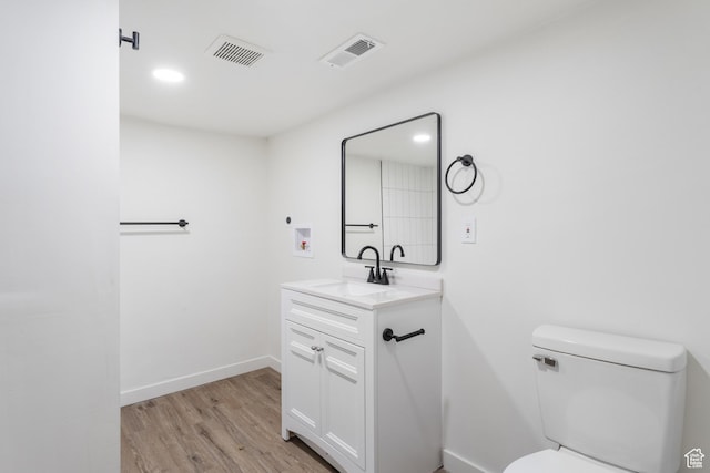 225 8th St, Ogden, UT 84404 - bathroom featuring toilet, vanity, and hardwood / wood-style floors