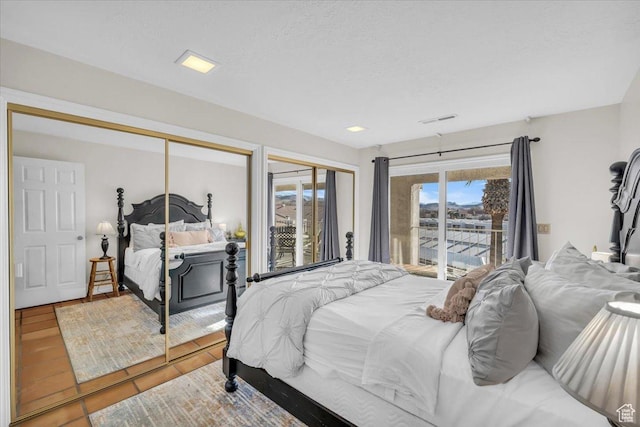 bedroom featuring tile patterned flooring and a textured ceiling