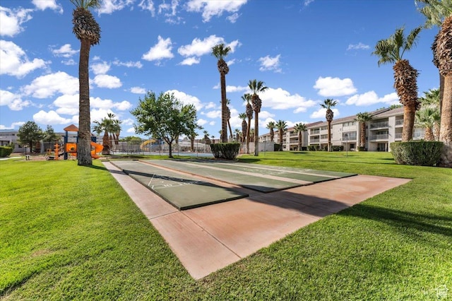 view of property's community featuring a yard and a playground