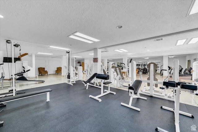 exercise room featuring a textured ceiling