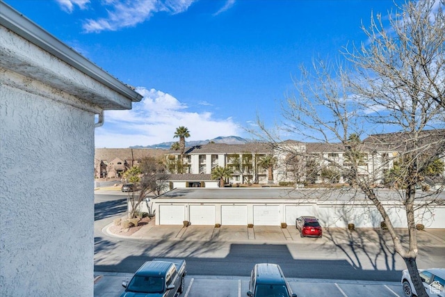 view of patio / terrace featuring a garage and a mountain view