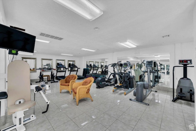 exercise room with a textured ceiling