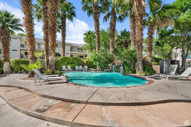 view of pool featuring pool water feature and a patio area