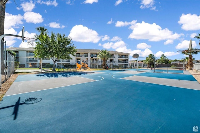 view of basketball court with tennis court and a playground