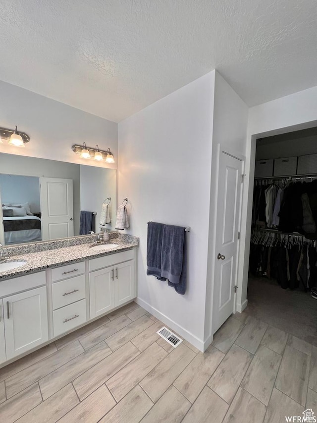 10052 Marigold Ln, Cedar Hills, UT 84062 - bathroom with a textured ceiling and vanity