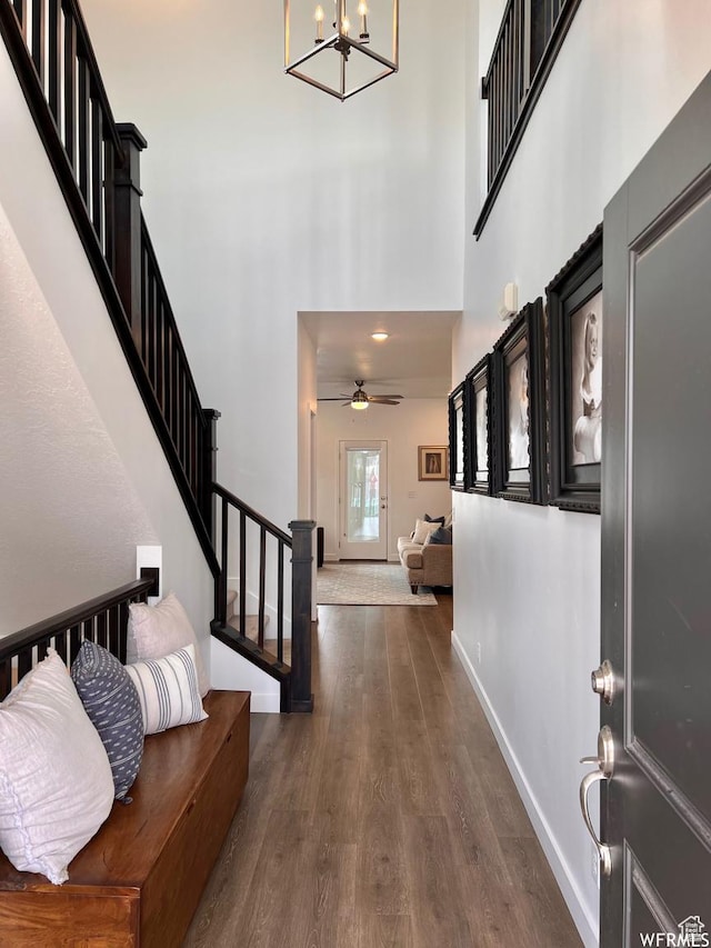 10052 Marigold Ln, Cedar Hills, UT 84062 - foyer entrance with ceiling fan with notable chandelier, a high ceiling, and dark hardwood / wood-style floors