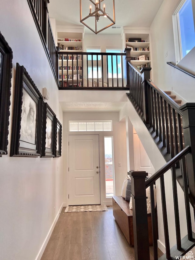 10052 Marigold Ln, Cedar Hills, UT 84062 - entryway with a high ceiling, a chandelier, and hardwood / wood-style flooring