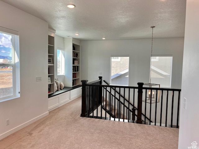 10052 Marigold Ln, Cedar Hills, UT 84062 - corridor with a textured ceiling, light colored carpet, and built in features