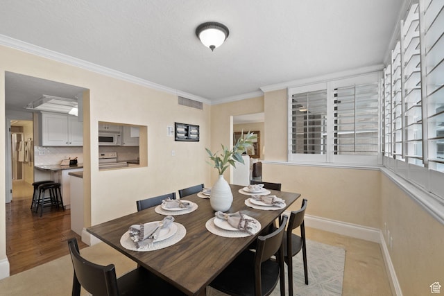 dining space with crown molding