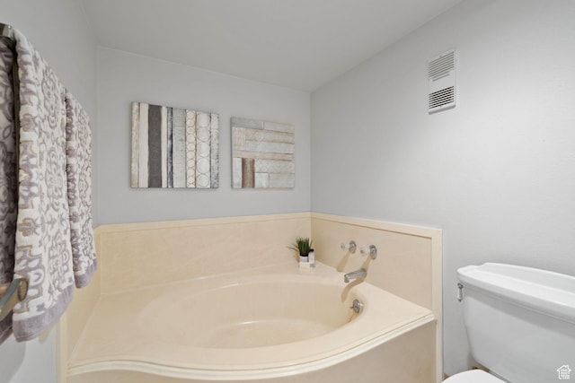 bathroom with toilet and a tub