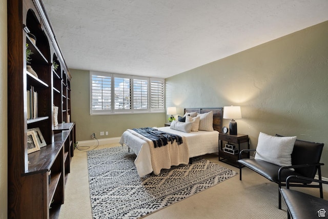 bedroom featuring a textured ceiling and light colored carpet