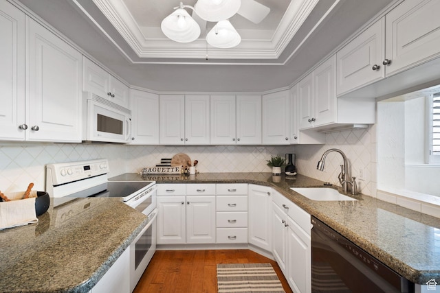 kitchen with white appliances, white cabinets, ornamental molding, and sink