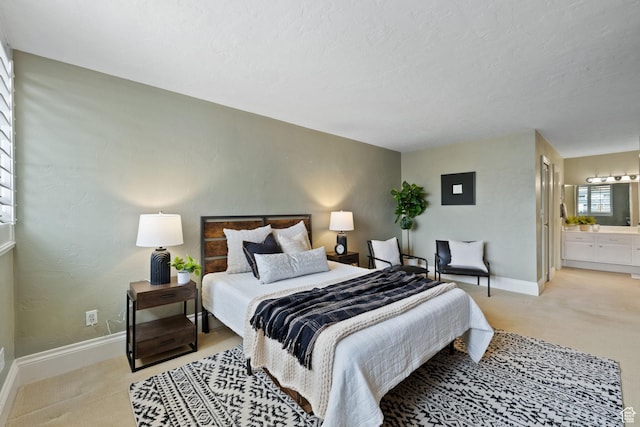 carpeted bedroom with ensuite bath