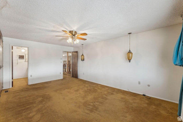 unfurnished room with ceiling fan, carpet, and a textured ceiling