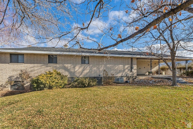 view of property exterior featuring a patio area and a yard