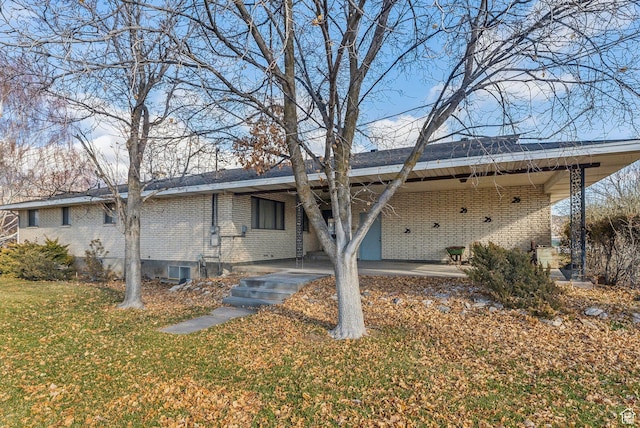 back of property featuring a yard and a carport
