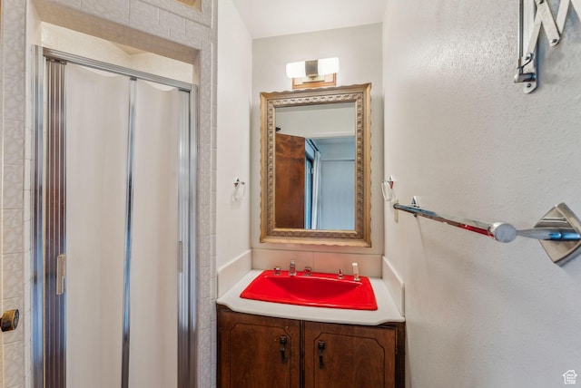 bathroom featuring vanity and a shower with shower door