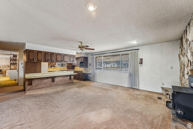 unfurnished living room featuring pool table, carpet flooring, a textured ceiling, and ceiling fan