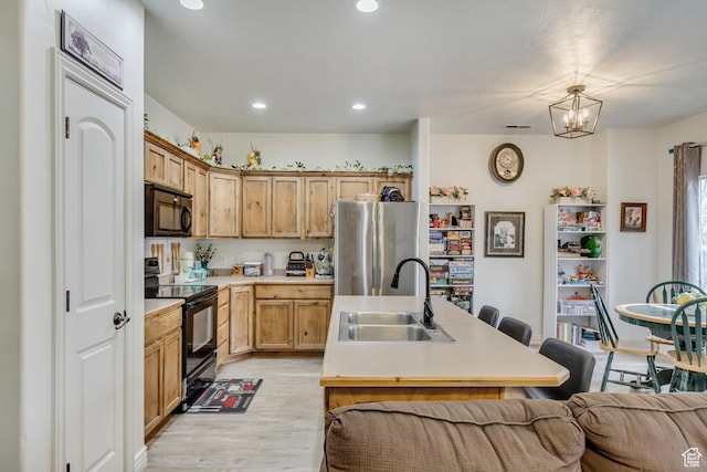 911 W 310 S, Pleasant Grove, UT 84062 - kitchen featuring decorative light fixtures, a notable chandelier, black appliances, light wood-type flooring, and sink