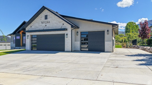 1244 N Washougal, Elk Ridge, UT 84651 - view of front facade with stone siding, an attached garage, and concrete driveway
