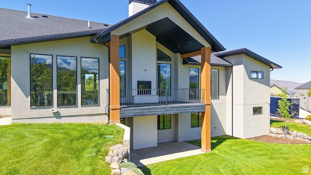 1244 N Washougal, Elk Ridge, UT 84651 - rear view of house featuring stucco siding, a lawn, a patio, and a chimney