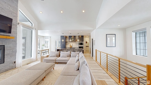 1244 N Washougal, Elk Ridge, UT 84651 - living room with light wood-style floors, a high ceiling, a fireplace, and recessed lighting
