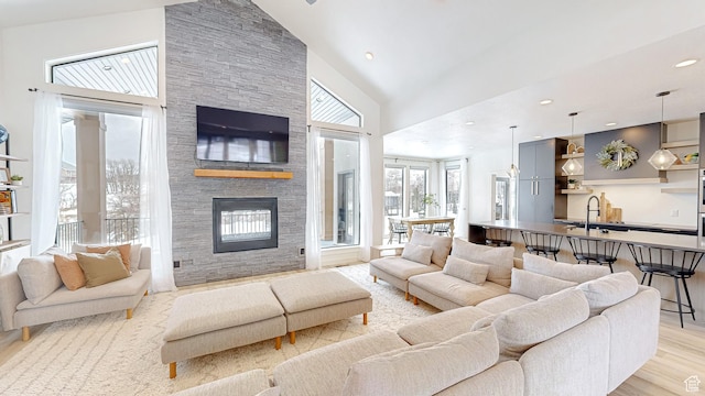 1244 N Washougal, Elk Ridge, UT 84651 - living room with high vaulted ceiling, a stone fireplace, light wood-style floors, and recessed lighting