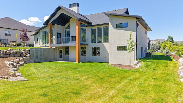 1244 N Washougal, Elk Ridge, UT 84651 - rear view of property with a balcony, stucco siding, a yard, a chimney, and central air condition unit