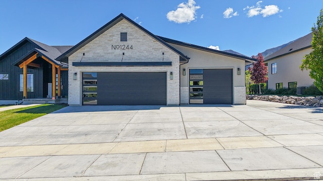 1244 N Washougal, Elk Ridge, UT 84651 - view of front of home with concrete driveway, an attached garage, and stone siding