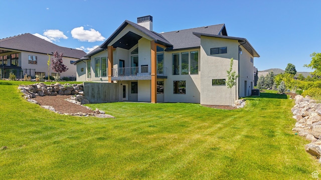1244 N Washougal, Elk Ridge, UT 84651 - back of house featuring a balcony, a chimney, stucco siding, a lawn, and central air condition unit