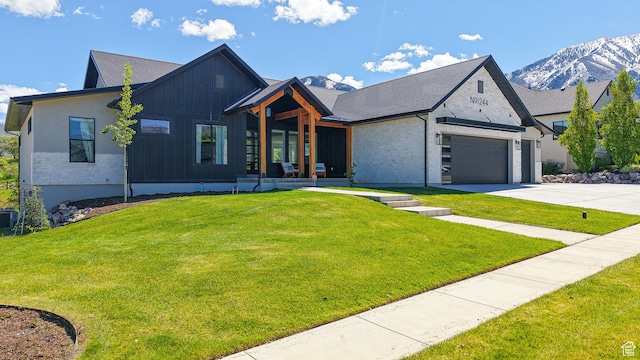 1244 N Washougal, Elk Ridge, UT 84651 - view of front facade with concrete driveway, a front yard, an attached garage, and a mountain view