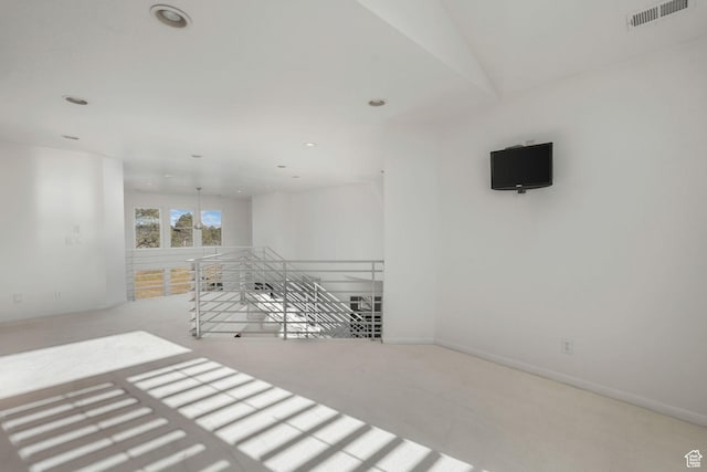 unfurnished room featuring light colored carpet