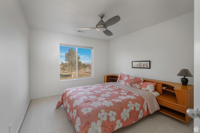 bedroom featuring light colored carpet and ceiling fan