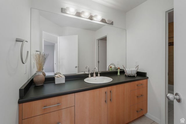 bathroom with tile patterned floors and vanity