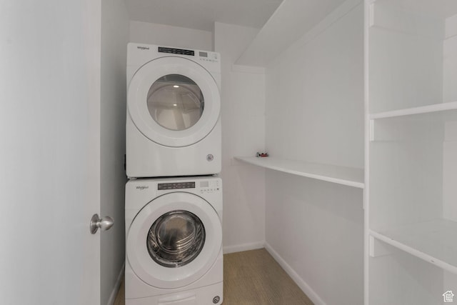 clothes washing area featuring stacked washer / drying machine