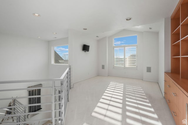 interior space featuring light carpet and a wealth of natural light