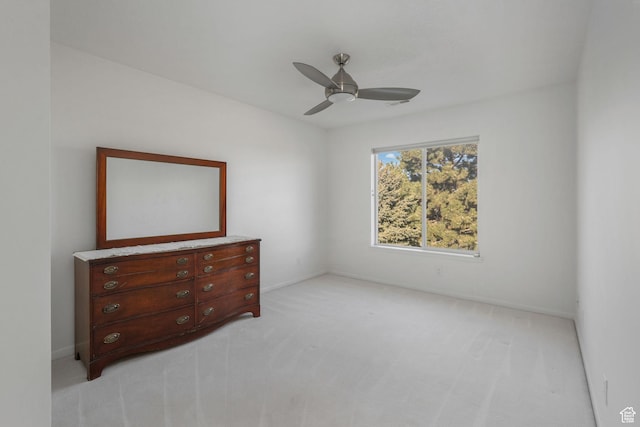 unfurnished bedroom featuring ceiling fan and light carpet