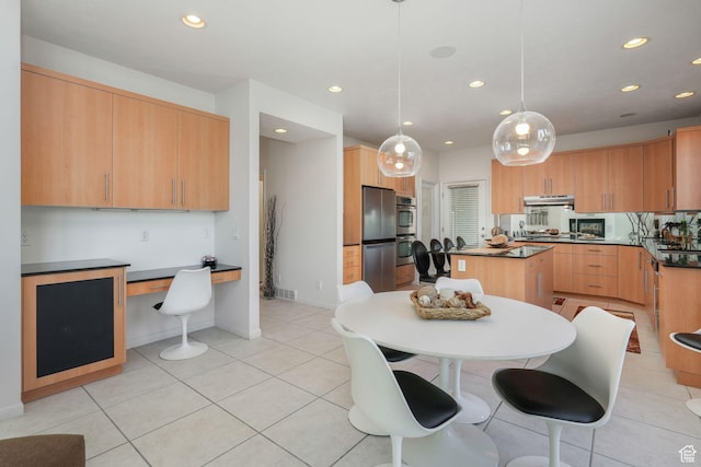 kitchen with light brown cabinets, decorative light fixtures, light tile patterned flooring, and stainless steel fridge
